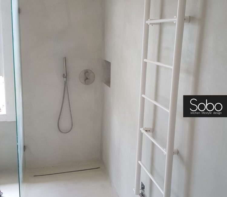 Bathroom basin, shower room, walls and floor coated in a very light grey microcement/microtopping by Sobo Design.