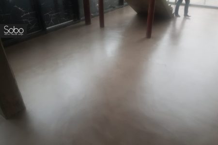 Office floor coated in 'latte/mocha' microcement
